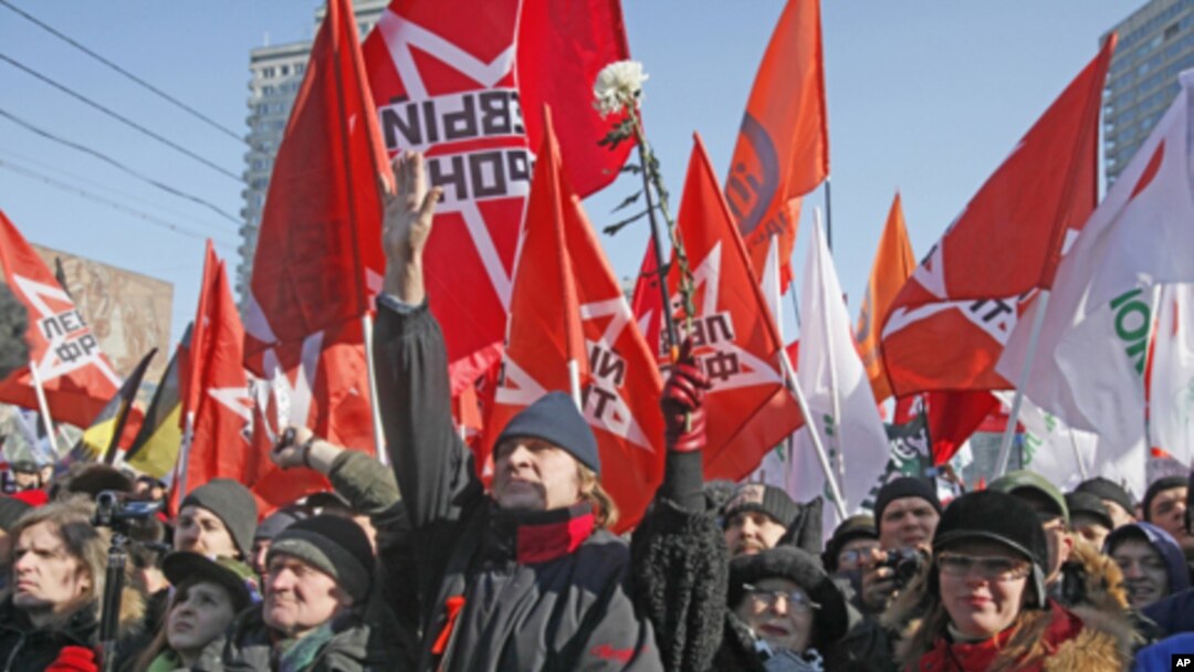 Opposition protesters with their flags shout anti-Putin's slogans as they gathered in the center of Moscow during a rally, Saturday, March 10, 2012.