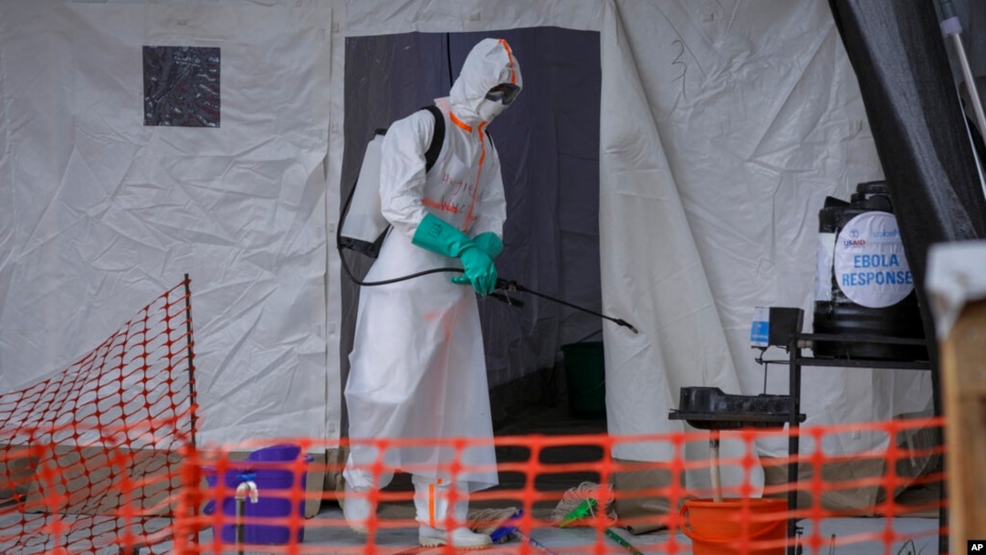 FILE - A medical worker disinfects a tent used for suspected Ebola victims inside the Ebola isolation center of Madudu Health Center III, in the village of Madudu, in the Mubende district of Uganda, Nov. 1, 2022. 