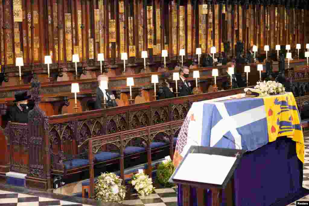 Queen Elizabeth II looks at the coffin of her husband, Prince Philip, who died at the age of 99, during his funeral service at St George's Chapel, in Windsor, April 17, 2021.