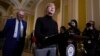 Democratic Senator Tammy Baldwin, at podium, joins Senate Democratic Majority Leader Chuck Schumer to talk about Democrats' efforts to pass the Respect for Marriage Act, at the Capitol in Washington, Nov. 15, 2022. The Senate advanced the bill 62-37 on Nov. 17.