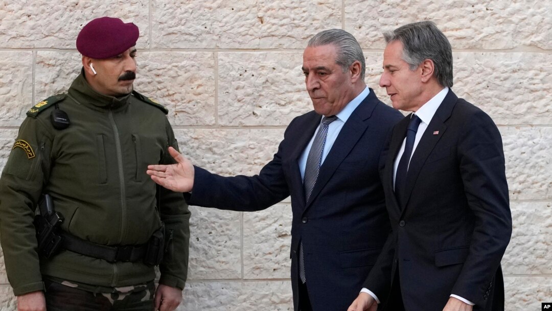 PLO Secretary General Hussein al-Sheikh, center, welcomes U.S. Secretary of State Antony Blinken, right, before his meeting with Palestinian President Mahmoud Abbas in the West Bank town of Ramallah, Feb. 7, 2024.
