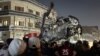 People inspect a vehicle after what security sources said was a deadly drone strike, in Baghdad, Iraq, Feb. 7, 2024.