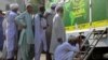Afghan refugees wait at a National Database and Registration Authority van for data verification, at a police station in Karachi on Nov. 8, 2023. Pakistan says terror attacks in the country are up, and foreigners without legal status are linked to people fueling such incidents.