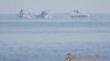 Chinese Coast Guard boats close to the floating barrier are pictured on Sept. 20, 2023, near the Scarborough Shoal in the South China Sea, in this handout image released by the Philippine Coast Guard on Sept. 24, 2023. (Handout via Reuters)
