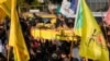 Fighters of the Popular Mobilization Forces carry the coffin of Wisam Mohammad al-Saedi, a commander of the Kataib Hezbollah paramilitary group, who was killed in a U.S. drone strike, in Baghdad, Iraq, Feb. 8, 2024.