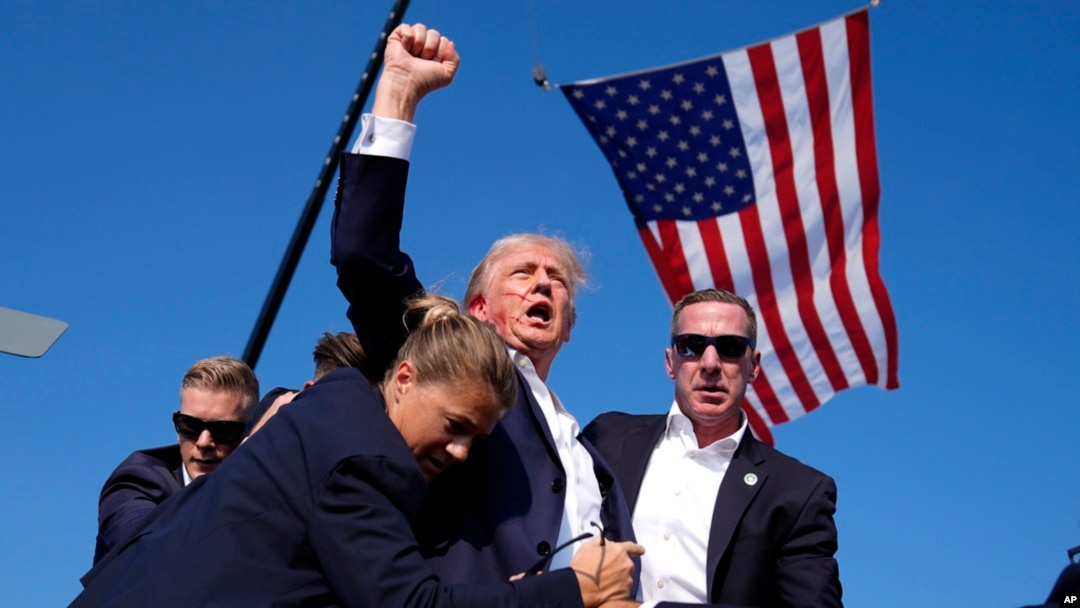 FILE - Republican presidential candidate former president Donald Trump is surrounded by U.S. Secret Service agents following an assassination attempt at a campaign rally, in Butler, Pennsylvania, July 13, 2024, in this image by AP journalist Evan Vucci.