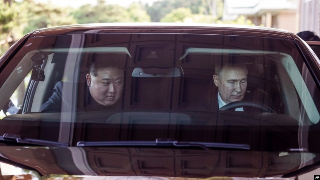 FILE - Russian President Vladimir Putin and North Korean leader Kim Jong Un drive a limousine during their meeting in Pyongyang, North Korea, June 19, 2024. NATO is expected to discuss the Russia-North Korea relationship at its summit July 9 to 11, 2024. (Kremlin photo via AP) 