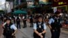 FILE - Police stand guard during an anniversary of the 1989 Tiananmen Square pro-democracy protest crackdown in Beijing, near where a candlelight vigil is usually held, in Hong Kong, June 4, 2023.