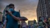 A man uses his smartphone in Beijing on Aug. 26, 2021. Human Rights Watch in a new report Aug. 16, 2023, found that racist content against Black people is increasingly common on the Chinese internet.