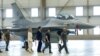 FILE - Ukrainian President Volodymyr Zelenskiy and Dutch Prime Minister Mark Rutte walk past an F-16 fighter jet in Eindhoven, Netherlands, Aug. 20, 2023.
