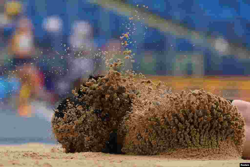 Turkey&#39;s Ecem Calagan lands in the sand after sustaining an injury during the Women&#39;s Long Jump during the European Games in Chorzow, Poland, June 25, 2023.