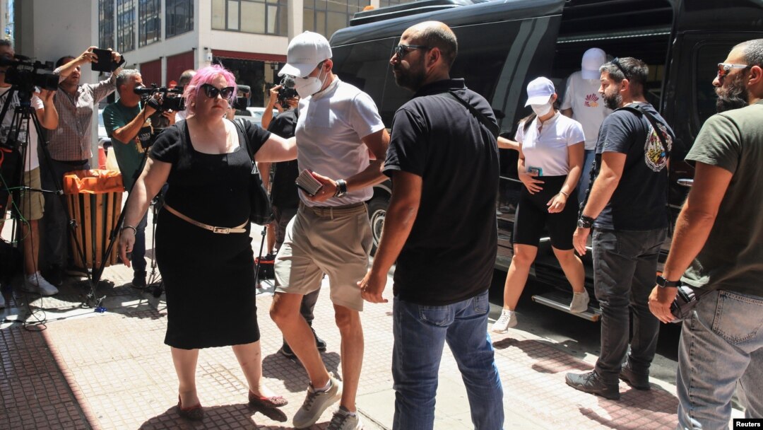 Yacht crew members, who allegedly caused a forest fire on the island of Hydra after launching fireworks from the vessel, are transferred to the prosecutor's office in Piraeus, Greece, June 23, 2024. (Giannis Panagopoulos/Eurokinissi via Reuters)