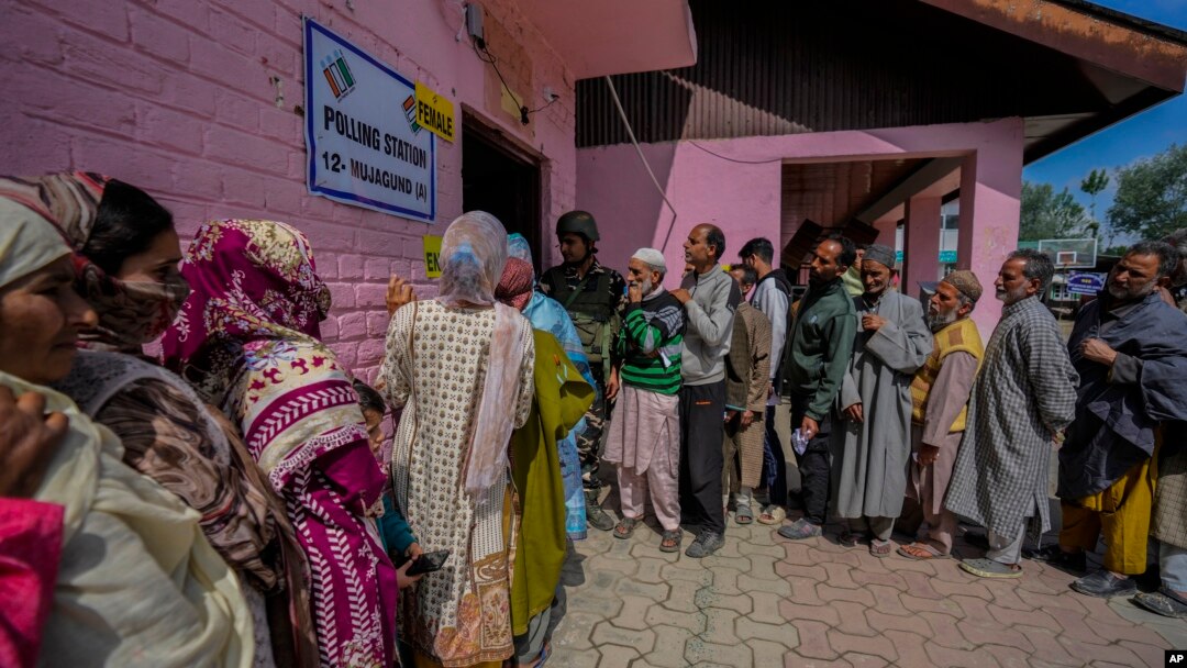 Men and women stand in separate queues to cast their votes during the fourth phase of India's general election, on the outskirts of Srinagar, Indian-administered Kashmir, May 13, 2024.