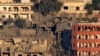FILE - Destroyed houses in Khiam, a town near the Lebanese-Israeli border, that was hit by Israeli air strikes on Friday June 21, seen from the Lebanese town of Marjayoun, Lebanon, June 22, 2024.