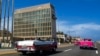 FILE - Tourists in classic cars pass the U.S. Embassy in Havana, Oct. 3, 2017. A Senate report on Dec. 27, 2024, criticized the CIA's response to Havana syndrome health problems. 