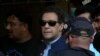 FILE - Pakistan's former Prime Minister Imran Khan is escorted by security officials as he arrives at court in Islamabad, Pakistan, May 12, 2023.