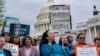 Analilia Mejia of the Center for Popular Democracy, center, joins other activists calling for ethics reform in the U.S. Supreme Court, at the Capitol in Washington, May 2, 2023. 