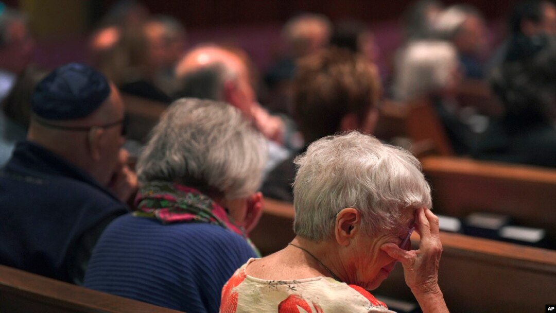 Anne Faigen, right, says a silent prayer for her friends in Israel while at a Shabbat service at Temple Sinai in Pittsburgh, Pennsylvania, Oct. 13, 2023.