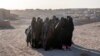 Afghan women mourn relatives killed in an earthquake at a burial site after an earthquake in Zinda Jan district, western of Afghanistan, Oct. 8, 2023. 