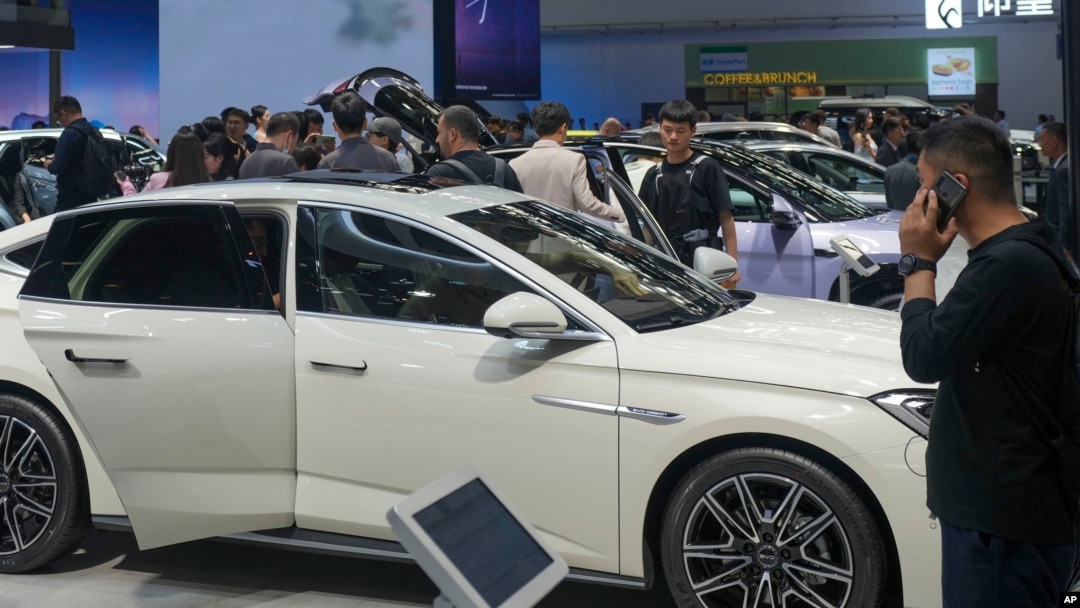 FILE - Visitors look at cars during the China Auto Show in Beijing, China, Apr. 26, 2024. The European Union in July imposed stiff tariffs on vehicles made in China after it found that the automakers got large government subsidies that undermined European rivals.