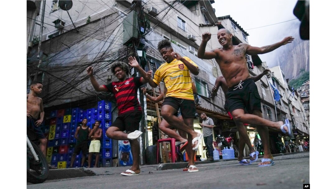 Youth perform a street dance style known as passinho for their social media accounts, in the Rocinha favela of Rio de Janeiro, Brazil, April 11, 2024. (AP Photo/Silvia Izquierdo, File)