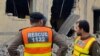 Rescuers stand at the site of an attack after militants rammed an explosive-laden vehicle into a Pakistan military base, in the town of Daraban of Dera Ismail Khan district, in Khyber Pakhtunkhwa province, on Dec. 12, 2023.
