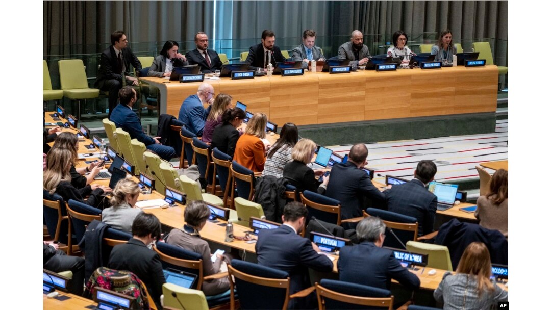 Illia Samoilenko, a Ukrainian soldier who fought in Mariupol and former prisoner of war, speaks at United Nations headquarters, Feb. 22, 2023. He is seated third from the left at the table on the podium.