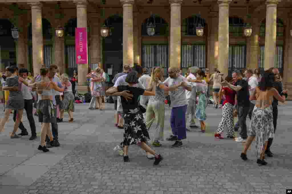 Couples dance on the final day of the 2024 Summer Olympics ahead of the closing ceremony, Aug. 11, 2024, in Paris, France.