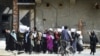 FILE - Afghan women hold placards as they march to protest in Kabul, April 29, 2023, to voice opposition to foreign nations formally recognizing the Taliban government ahead of a U.N. summit.