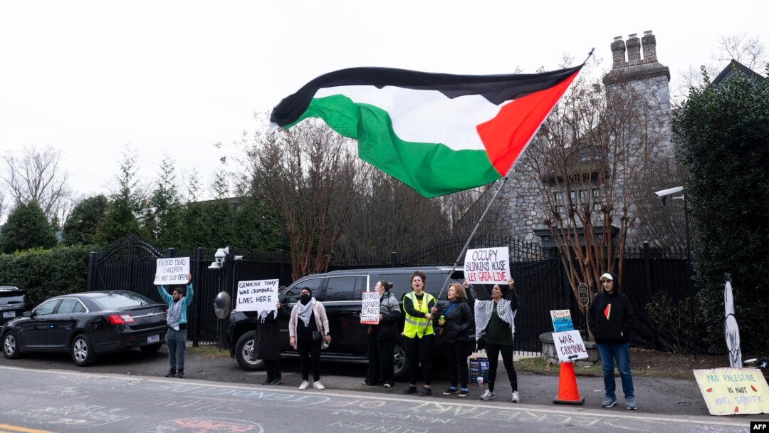 Protesters call for a cease-fire in the Israel-Hamas war as they demonstrate outside the home of US Secretary of State Antony Blinken in Arlington, Virginia, on Jan. 27, 2024.