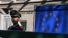 FILE - A Chinese paramilitary policeman stands guard at the entrance to the European Union Delegation to China compound in Beijing, China, Oct. 14, 2023. 