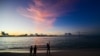 FILE - People walk along a beach at Vilimalé island in the the Maldives on Nov. 15, 2023. 