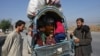 Afghan nationals are pictured along a road in the Jamrud area of Khyber district, 30 km west of Peshawar, Oct. 6, 2023, as they return to Afghanistan following the Pakistan's government decision to expel people illegally staying in the country.