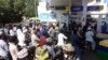 FILE - People wait in lines at a petrol station in Karachi, Pakistan, Nov. 25, 2021. Government officials blame the country’s economic woes on the global rise in the cost of food and fuel due to supply chain issues caused by the COVID-19 pandemic and Russia's war in Ukraine.