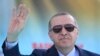 Turkey's President Recep Tayyip Erdogan waves to supporters as he attends an opening ceremony for a rail commute line in Ankara, Turkey, April 12, 2018.