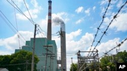 In this file photo from June 10, 2021, a flume of emissions flow from a stack at a coal-fired power plant, in Springdale, Pa. A report released Nov. 20, 2022 argues fossil fuels are the cause, not the solution, to the current energy crisis. 