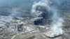 This handout video grab taken from a footage released by Mariupol City Council on Apr. 19, 2022 shows clouds of smoke billowing above Azovstal steel plant and the destroyed gates of Azov Shipyard. (Photo by Handout / Mariupol City Council / AFP)