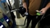 FILE - A customer prepares to pump gasoline into his car at a Sam's Club fuel island in Gulfport, Miss., Feb. 19, 2022. The U.S. economy shrank last quarter for the first time since the pandemic recession struck two years ago, the government reported April 28, 2022.