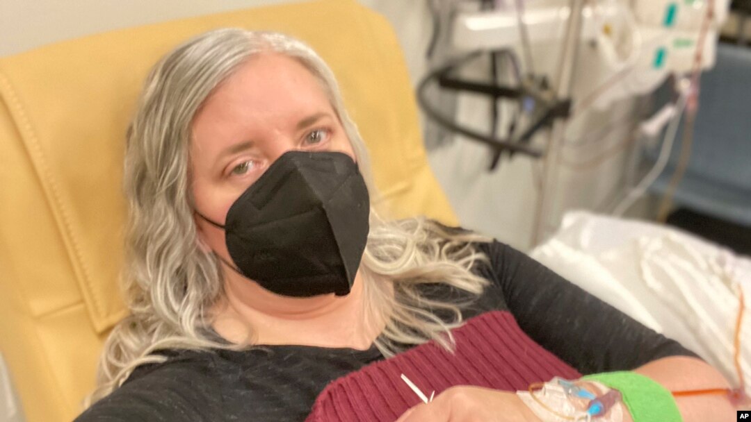 This photo provided by Amy Watson of Portland, Ore., shows her during an iron infusion in December 2022. 