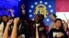 Supporters cheer during an election night watch party for Democratic Sen. Raphael Warnock, Dec. 6, 2022, in Atlanta. Sen. Warnock has defeated Republican challenger Herschel Walker in a runoff election in Georgia.