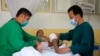 FILE - An Afghan boy receives medical care at the International Committee of the Red Cross physical rehabilitation center after being injured in fighting between the Taliban and Afghan security personnel, in Kabul, Afghanistan, Aug. 10, 2021.
