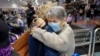 FILE - Relatives embrace after a flight from Los Angeles arrived at Auckland International Airport as New Zealand's border opened for visa-waiver countries, May 2, 2022.