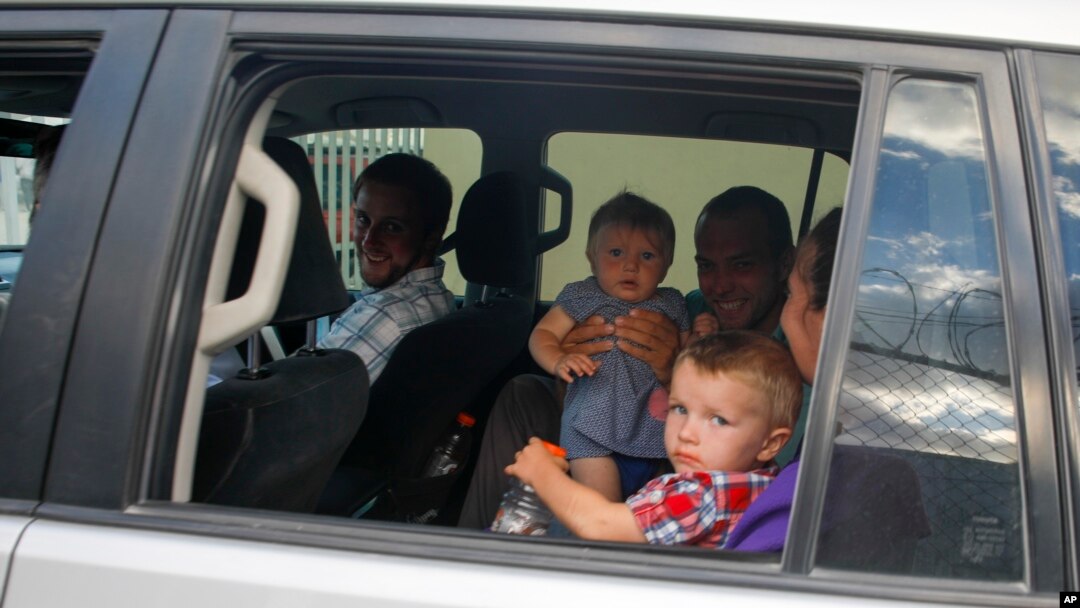 Unidentified people depart on route to the airport from the Christian Aid Ministries headquarters at Titanyen, north of Port-au-Prince, Haiti, Dec. 16, 2021.