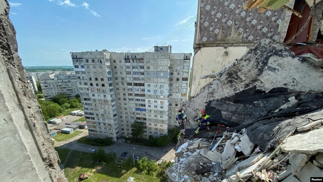 Rescuers work at a residential building damaged by shelling in the past, as Russia's attack on Ukraine continues, in Kharkiv, Ukraine, May 31, 2022.