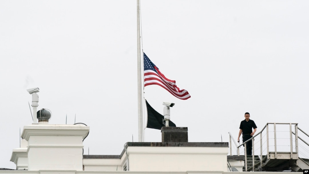 An American flag flies at half-staff at the White House, May 24, 2022, in Washington, to honor the victims of the mass shooting at Robb Elementary School in Uvalde, Texas.
