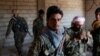 FILE - Kurdish fighters from the People's Protection Units (YPG) stand in a house in Raqqa, Syria, June 21, 2017. While welcoming the ouster of jihadist from the city, local Arabs are suspicious of the advancing Kurds' long-term intentions.