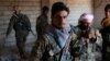 FILE - Kurdish fighters from the People's Protection Units (YPG) stand in a house in Raqqa, Syria, June 21, 2017. 