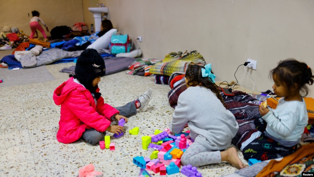 Migrant girls, traveling from Venezuela with their family, play in a shelter near the border between the US and Mexico, after the U.S. Supreme Court said on Tuesday that it will keep Title 42 in force for now, in Ciudad Juarez, Mexico, Dec. 27, 2022. 