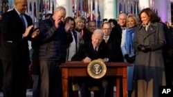 President Joe Biden signs the Respect for Marriage Act, Dec. 13, 2022, on the South Lawn of the White House in Washington.