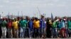 Mine workers protest outside the Lonmin mine in Rustenburg, northwest of Johannesburg, Jan. 23, 2014. 